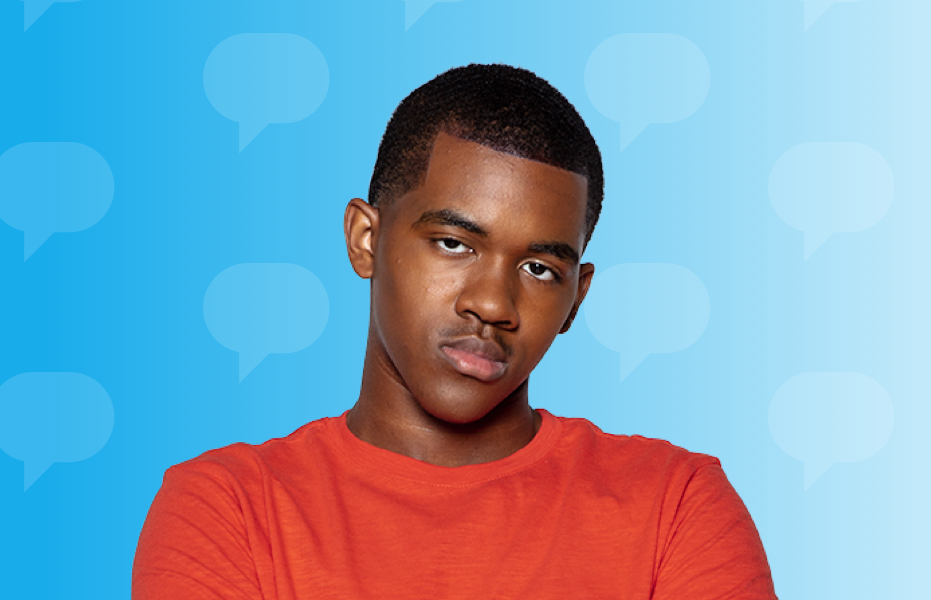 A teenager in a red t-shirt against a blue background looking directly ahead with a serious expression.