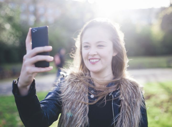 Teenage girl taking selfie – Talking to your teenager about what they’ve seen online or in the media 
