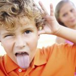 Boy pulling face – The difference between teasing and bullying