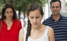 Sad teenage girl turns her back on her parents