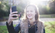 Teenage girl taking selfie – Talking to your teenager about what they’ve seen online or in the media 